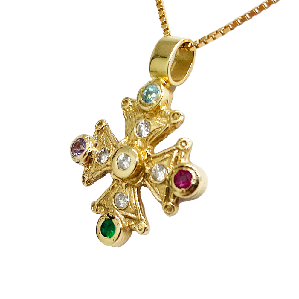 Gold cross pendant with multicolored gemstones. The cross features a central diamond.